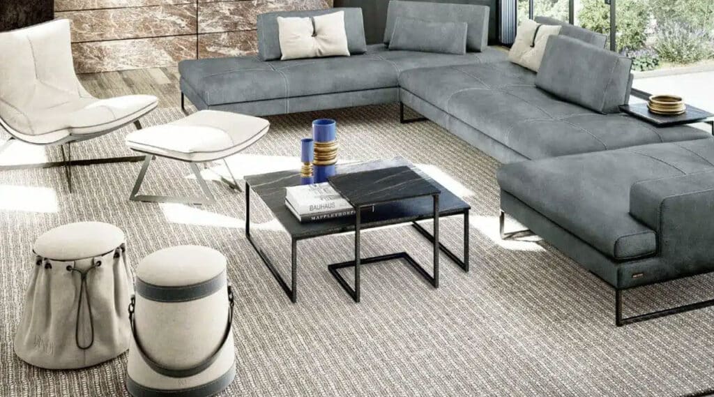 Black coffee table in modern living room styled with a gray couch and white chair.